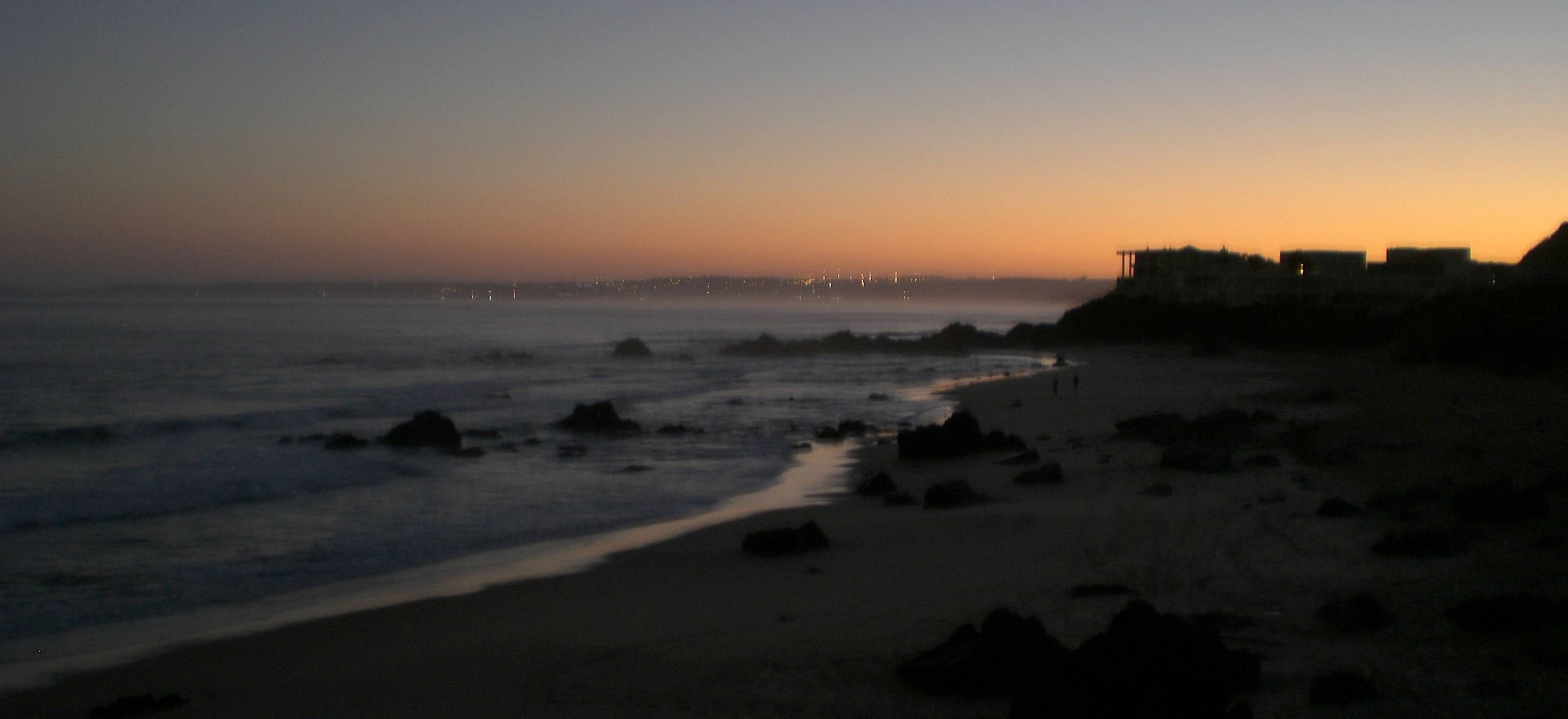 Keurbooms beach at dusk with the lights of Plettenberg Bay across the water